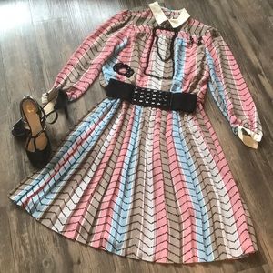 A tan, blue, pink, blue, and black dress